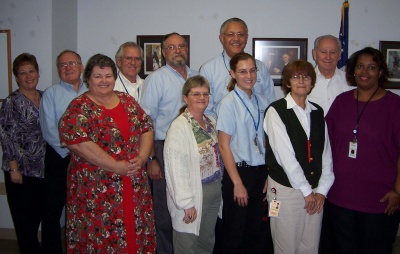 St. Mary’s County Health Department’s Medical Transportation Program team (back row left to right) Cindy Spalding, administrative officer; Harry Nelson, Michael Esch, Al Richards, Alan Scott, and George Goodwin, drivers; (front row left to right) Patti Whorl, office supervisor; Janet Williams, office services clerk; Cheryl Burton and Helen Goodwin, drivers; and Kim Fenwick, office services clerk.