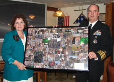 PAXRVR NAS Executive Officer Captain Andrew Macyko presented the men and women of the Moose, Hollywood, Md. with a collage of different photos depicting the activities of the soldiers of the 4th Army Brigade, 2nd Infantry Division, Stryker Brigade Combat Team as they go through their daily routines in Iraq. A U.S. flag that was flown over the NAS and Camp Taji in the Northern Baghdad Provence was also presented.