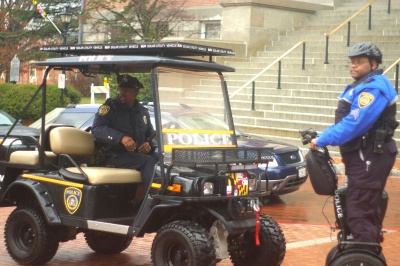 Sgt. Greg Harris and Sgt. Derwyn Parker of the Department of General Services patrol the State House complex using a solar-powered utility vehicle and a rechargeable Segway on January 11. Police Chief Michael Pristoop estimates the department's use of the green vehicles saves hundreds of dollars each week. (Capital News Service Photo by Kate Elizabeth Queram)