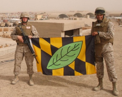 Pictured with the Calvert County flag in Iraq are U.S. Marines Lt. Cpl. Jeremy Gott (left) and SSgt. Michael W. Pitcher. Both men are from Lusby in Calvert County.