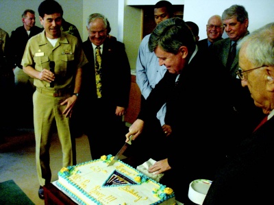 Sen. Roy Dyson (D-Dist. 29) cuts the birthday cake along with Capt. Glen Ives, commander of Patuxent River Naval Air Station and members of the St. Mary’s County Board of County Commissioners for the 65th anniversary of the naval air station’s commissioning.