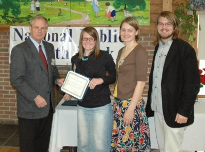 Dr. William B. Icenhower, St. Mary's County health officer, presents the Public Health Hero certificate to St. Mary's College of Maryland students Erin McDermott (left), Bonnie Veblen and Shane Hall at a Public Health Week awards breakfast. (Photo: Marc Apter)