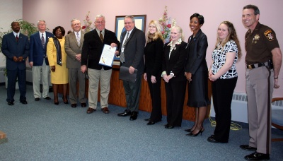 The Charles County Commissioners present the proclamation designating the week of April 13 as “Protecting Our Children Week.” Pictured with the Commissioners are: Mike Luginbill, Manager, Human Services Partnership; Dr. Rebecca Bridgett, Director, Charles County Social Services; Catherine Myers, Executive Director, Center for Children; Tanisha Sanders, Human Services Specialist, Human Services Partnership; Candice Nelson, Child & Adolescent Planning Specialist, Human Services Partnership; and Sheriff Rex Coffey. (Photo: George Clarkson)