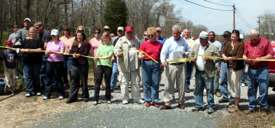 Leading the formal ribbon-cutting for the refurbished Mason Springs fishing grounds is Dennis Fleming (fourth from right), President of the Mason Springs Conservancy. (Photo: George Clarkson) 