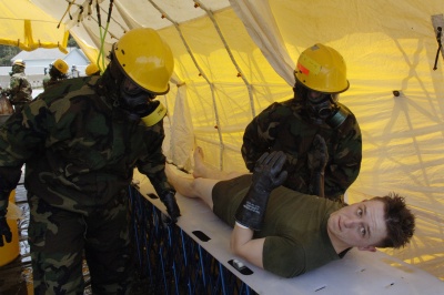 A simulated victim of a chemical attack is decontaminated by members of the Chemical Biological Incident Response Force during a National Level Exercise at Fort Lewis, Wash. The Marine Corps response unit, from Indian Head, Md., is a one-of-a-kind initial response force. (Photo: Air Force Tech.Sgt. Larry Simmons)