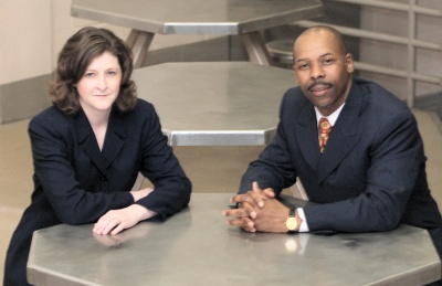 John Lewis has been named the new chaplain for the Charles County Detention Center. Sgt. Tracy Williams, right, supervisor of the Classification and Treatment Unit, sits with Lewis in the center. (Photo: CCSO)