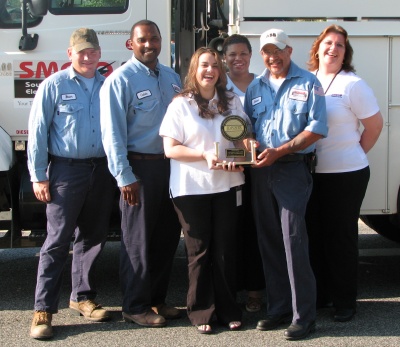 Some SMECO field employees and customer service representatives display SMECO's recent J.D. Power award for customer satisfaction. From left are Brian Rawlings, Calvin Thomas, Kimberly Farrell, Diamond Lewis, Shawn Harley, and Fay Wood.