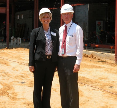 Kim Summers, the new principal of Evergreen Elementary School and alumna of St. Mary's College of Maryland, and Larry Hartwick, supervisor of design and construction for St. Mary's County Public Schools, don hardhats at the school's construction site. (Submitted Photo)