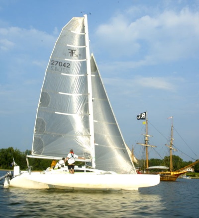 Temple of The Wind, from Arnold Md., approaches the finish line of the 2008 Governor's Cup in St. Mary's City. The line between the Mast bearing the Race Committee flag on the mast of the Maryland Dove and the cross at Priest's Point on the shore marks the finish line. (Photo: D. Noss)