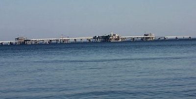 The Cove Point LNG offloading pier in the Chesapeake Bay off the coastline of Calvert County, as seen from Calvert Cliffs Park. (SoMd.com File Photo)