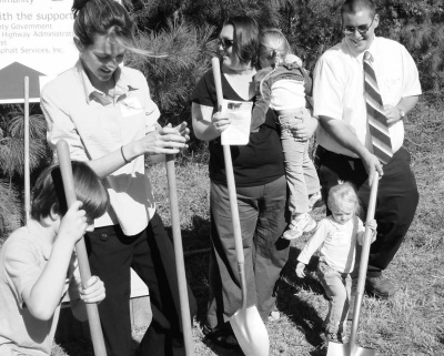 Gus Dunn, left, and his mother Catherine Dunn break ground with the Tiffandy and Bill Shreve and their two daughters Autumn and Lacey at the Patuxent Habitat for Humanity affordable housing project at Fenwick Ridge in Lexington Park Tuesday. (Photo: Guy Leonard)