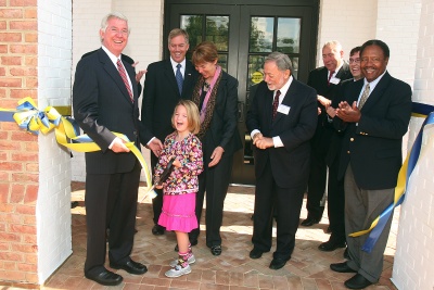 Gov. Parris N. Glendening (left) helped his daughter Bri cut the ribbon during the dedication ceremony of Glendening Hall on the St. Mary's College of Maryland campus. Also attending the ceremony were (from left) Del. John Bohanan, SMCM President Jane Margaret "Maggie" O'Brien, Chair of the SMCM Board of Trustees James P. Muldoon, SMCM Board of Trustees Building and Grounds Committee Chair Michael O'Brien, SMCM Student Trustee Jeremy Pevner, and Secretary of the Maryland Department of General Services Alvin C. Collins. (Photo: Darrin Farrell)