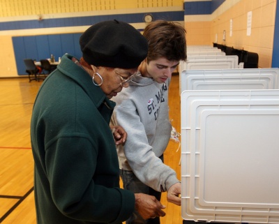 Sam Birnbaum, a St. Mary's College of Maryland senior and St. Mary's Votes! organizer, assisted Elizabeth Swales of Hollywood at the Leonardtown High School polling station during the presidential primaries and will help voters there again on Nov. 4. (Photo: James A. Parcell)