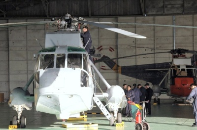 Armada Argentina maintainers conduct some maintenance checks on Sea King 241 and 240 (orange and white Sea King in background). (U.S. Navy photo)