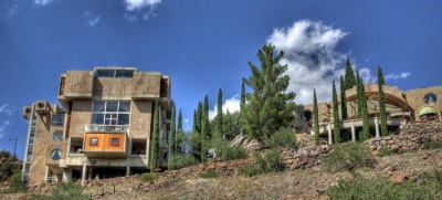 Some 420 eco-villages exist in both urban and rural settings around the world today. Pictured here: the west end of Arcosanti, a self-described "experimental town" in Arizona that has been under construction since 1970. In keeping with the concept of clustered development so as to maximize open space and the efficient use of resources, the large, compact structures and large-scale solar greenhouses of Arcosanti occupy a small footprint—only 25 acres within the community's 4,000-acre "land preserve." (Photo: CodyR, courtesy Flickr)