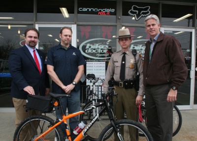 The Bike Doctor of Waldorf and MD State Trooper Joe Wilson donate a Cannondale Mountain Bike to be used for patrol on the County's new Indian Head Rail Trail. The bike is fully accessorized and comes with a lifetime service agreement. Pictured (from left) are Paul Comfort - County Administrator, Chris Richardson - Bike Doctor's Owner, Trooper Joe Wilson and Tom Roland - Chief of Parks & Recreation.