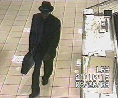 The suspect is described as a black male, about 5'4", with a slim build. At the time of the robbery, he was wearing a gray suit, brimmed hat, and sunglasses. Anyone with information is asked to call Detective B. Buchanan at (301) 609-6477.