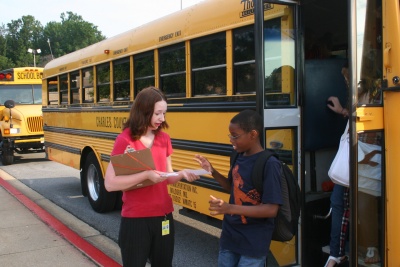 John Hanson Middle School special education teacher Jennifer Connelly, right, greets a Hanson student, left, as he arrives on the school bus for the first day of school Monday, Aug. 24. Charles County Public Schools opened its doors today for the 2009-2010 school year. (Submitted photo)