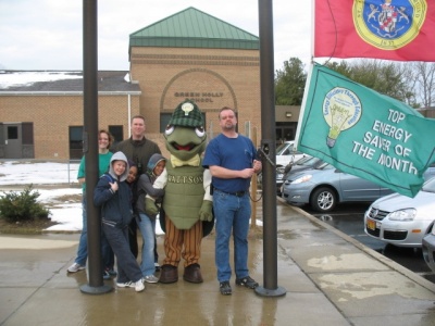 School officials and students at Green Holly Elementary School hoist the 'energy saver' flag or the first time on Friday. The school received the energy saver of the month distinction for Jan. 2009. (Submitted photo)