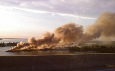 A photograph taken from the Thomas Johnson bridge Tuesday evening, from a vehicle headed north into Calvert County from St. Mary's County, shows the pier at the NAS's Solomons Annex completely engulfed in smoke and flames. A Navy ship can be seen tied up on the down-river side of the pier. (Photo: Wayne Devereux)