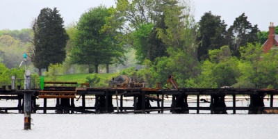 This photo taken Wednesday afternoon shows the extent of the damage on the Navy's pier at the Solomons Annex. Click for larger photo. Witnesses report the end of the pier was smoking Wednesday afternoon. (Photo: David Noss)