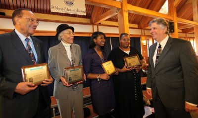 Winners of the first annual Martin Luther King, Jr., “Realizing the Dream” awards were honored today at the sixth annual MLK Prayer Breakfast, held at St. Mary’s College of Maryland (SMCM). Four winners from St. Mary’s County were honored with plaques and a $100 check because they embodied exemplary character as described in King's “I Have a Dream” speech and made significant contributions to St. Mary’s County. Winners included Theodore Newkirk, of Lexington Park, Maryland (from left); Everlyn Holland, of Hollywood, Maryland; Aamon Smith, of Great Mills, Maryland, and Donald Shubrooks, whose mother, Jacqueline Shubrooks, of California, Maryland, accepted the award on his behalf. The winners are congratulated by St. Mary’s College of Maryland acting president, Larry Vote. (Submitted photo)