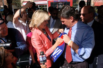 Former Gov. Robert Ehrlich Jr. and his wife, Kendel, sign a recycled 2006 campaign poster Wednesday at a Rockville rally that kicked off Ehrlich's 2010 candidacy for governor. (Capital News Service Photo by Graham Moomaw)
