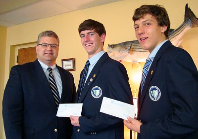 St. Mary's Ryken Principal Rick Wood (left) presents Brendan Walsh (center) and Zach Griffitt with the award checks from the Rotary Club of Lexington Park's annual "Four-Way Test" speech contest. (Submitted photo)