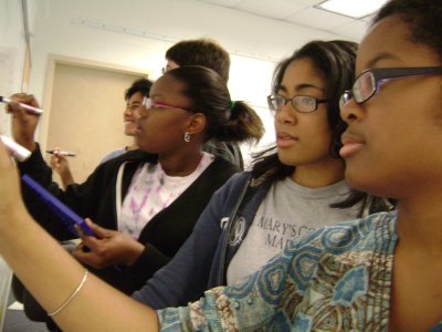 Anika Green ’12, Bethany Townsend ’12, and Thaise Brower ’12 solve math problems on the board at this year’s summer research experience at St. Mary’s College of Maryland. Stemming from the success of the current summer research experience, the mathematics and computer science department was recently awarded a $265,000 grant by the National Science Foundation to establish a Research Experience for Undergraduates. The program will begin in 2011 and will bring talented underrepresented mathematics undergraduates from across the country to St. Mary’s College to give them research opportunities that will help them succeed in mathematics classes and prepare them for degrees in mathematics or other science fields. (Submitted photo)