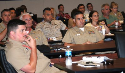 Military and industry partners listen to various scenarios presented during Navy Chemical, Biological and Radiological (CBR) Defense War Game Tabletop Exercise 2010 held at Naval Surface Warfare Center Dahlgren Laboratory Aug 9-13. More than 45 warfighters and civilians responding to simulated emerging threats throughout the event, assessed the capabilities necessary to sustain operational tempo in a CBR environment. (MC1 Scott Vanderwyst/USN)