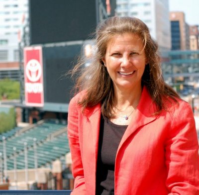 Janet Marie Smith, vice president of planning and development for the Baltimore Orioles, stands on a pedestrian bridge that connects Oriole Park to the Camden Yards Warehouse. (Photo: Steve Kilar)