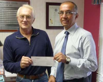 Carl Wood, CalvART Gallery president, presents Calvert Hospice director Peter Briguglio with a donation check for $430. (Submitted photo)