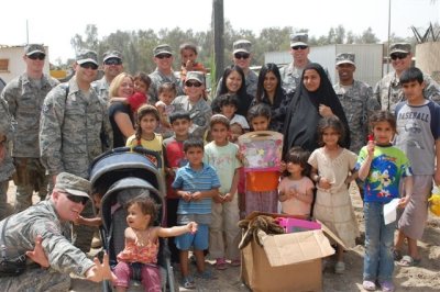 Vicki Leonard and members of the Multinational Security Transition Command – Iraq (MNSTC-I) team deliver toys, clothing and other items to Iraqi families donated by American families somewhere in Baghdad, Iraq. U.S. Navy photo by Vicki Leonard.