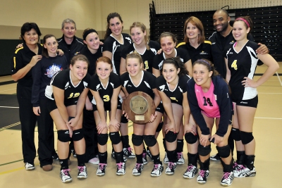The Lady Hawks volleyball team gathers around its Region XX runner-up award. With a post-season record of 26-12, CSM’s volleyball team is ranked 19th in the nation. (Photo: CSM)