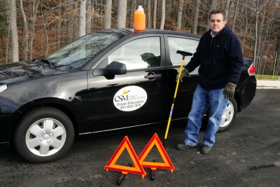 CSM Lead Drivers Education Coordinator/Instructor Mike Whelan shows off one of CSM’s drivers education vehicles and some essential winter driving items to keep in your car during winter months. (Submitted photo)