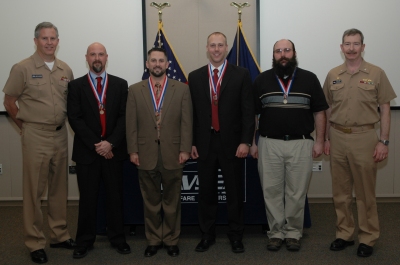 From Left to Right: Rear Admiral James Shannon, Commander, NSWC, Shane Sisemore, Tim Berry, Ross Stadsklev, Peter Paquette, Captain Michael H. Smith, Commander NSWCDD (Not present were Charles Bakker and Daniel Fredrikson) (Photo: NWSCDD)