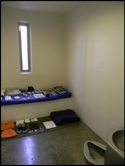 A sample prison cell in Camp Five displays the personal items detainees are permitted to own. Prisoners may spend up to 22 hours per day in the 92-square-foot cells. (Photo: Laura Lee)
