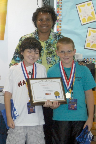 Matula fourth graders Joey Walsh, pictured left, and Michael Gill, pictured right, are congratulated for their top performance in the First in Math online challenge by their teacher, E. Diane Simmons, pictured back. Gill ranked first at Matula and 16th nationwide; Walsh earned second place among his peers at Matula and 23rd place nationwide. (Submitted photo)