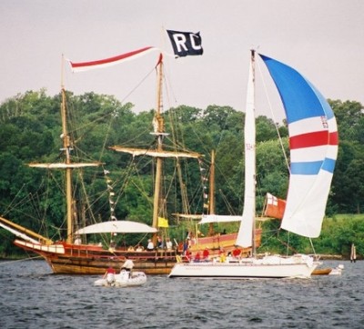 A boat crosses the finish line just off of Priest's Point, near the SMCM campus, in a prior year's Governor's Cup race. The black "RC" flag on the Maryland Dove, which stands for "Race Committee," marks the finish line. (somd.com file photo)