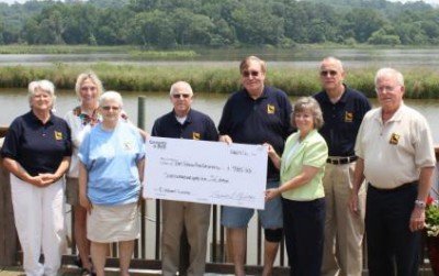 Becky Henderson, Community Bank of Tri-County, presents a donation to the Port Tobacco River Conservancy (PTRC) Board of Directors (including Jerry Forbes, PTRC President, Joyce Dean, Kathy Babiak, Joe Tieger, Charles Jackson, Connie Dunbar, Founder and PTRC Member, and Dave Gardner, PTRC Executive Director). (PRNewsFoto/Community Bank of Tri-County)