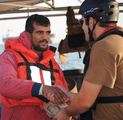 An Iranian mariner, rescued from the distressed Iranian-flagged dhow Ya-Hussayn, shakes hands with a Coast Guardsman from the Coast Guard Cutter Monomoy here, Jan. 10, 2012. The Monomoy rescued six Iranian mariners who abandoned the dhow after its engine room flooded. (Photo: U.S. Coast Guard)
