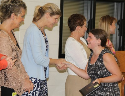 Graduate Samantha Noel, pictured right center, accepts a diploma from Board of Education Vice Chairman Maura Cook, second from left, and Arden Sotomayor, director of special education for Charles County Public Schools, left, at the 2012 Adult Independence Program graduation ceremony held May 18 at North Point High School.