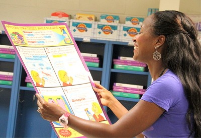 J.C. Parks Elementary School kindergarten teacher Arin Bonner prepares to hang a reading poster on her classroom wall during the first day back for Charles County Public Schools teachers on Tuesday, Aug. 21. School starts for students on Monday, Aug. 27. (Submitted photo)