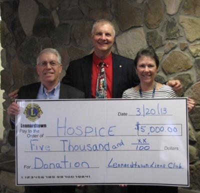 Leonardtown Lions David Guyther (left) and George Kirby (King Lion) present a $5,000 donation to Kathryn Franzen, Director of the St Mary's County Hospice.