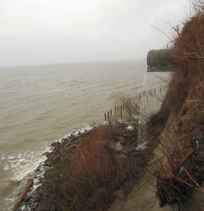 Erosion has exposed a drainage pipe in a cliff in Calvert County, and the houses above it are at risk. (Photo: Sydney Paul)