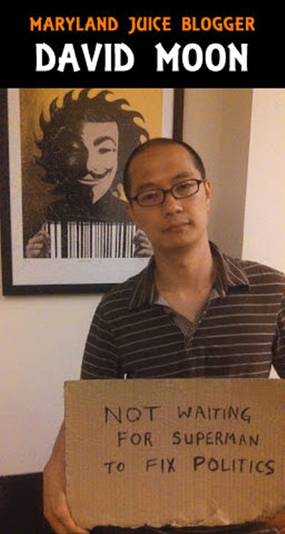 David Moon poses in front of an artwork depicting a character wearing a Guy Fawkes mask and holding a bar code. The Guy Fawkes mask was recently brought into the public consciousness via the 2005 film V for Vendetta and is a symbol of citizens fighting back against state tyranny.