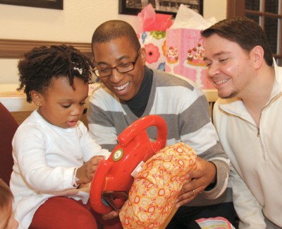 Chris Maulden-Locke (center) and Doug Maulden-Locke (right), a same-sex couple, adopted their daughter Mya (left) in Montgomery County in February. (Photo courtesy of the Maulden-Lockes)