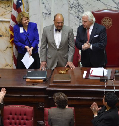 Darryl Hill is applauded by Maryland Senate President Thomas V. "Mike" Miller Jr., and lawmakers Tuesday in the State House. (Photo: Tamieka Briscoe)