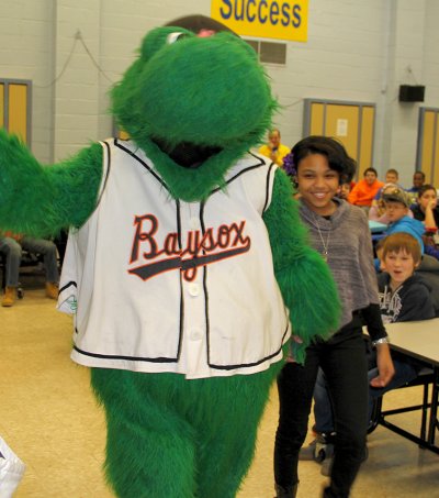 Louie, the mascot for the Bowie Baysox minor league baseball team, pulls General Smallwood Middle School student Jania Washington from a crowd of her peers during a special assembly at the school on Jan. 31. At the assembly, Washington was announced as Charles County’s winner of the Baysox’s Read and Hit a Home Run poster design contest. Washington’s design was selected from among more than 400 entries from Charles County students and will be featured on a poster for use in participating schools.