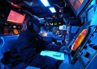 PHILIPPINE SEA - A Sailor stands watch in the Combat Information Center aboard the Ticonderoga-class guided missile cruiser USS Mobile Bay (CG 53). USS SECURE Project Lead Adam Simonoff received the Department of the Navy Information Management/Information Technology (IM/IT) Excellence Award Feb. 11 for his work with USS SECURE - a standalone cybersecurity test bed that determines the best combination of cyberdefense technologies to secure a naval combatant such as the Mobile Bay, without impacting real time deadline scheduled performance requirements. Simonoff - a Naval Surface Warfare Center Dahlgren Division cybersecurity engineer - anticipates that USS SECURE's successful cyberdefense technologies will transition into the fleet and will be offered throughout DoD and the Department of Homeland Security to protect and defend the nation's critical infrastructure. U.S. Navy photo by Photographer's Mate Airman James R. Evans (Released)